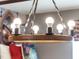 A rustic chandelier with multiple lights at 1607 Kona Ln, Davenport, FL 33897