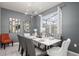 Elegant dining room with stylish light fixture, modern decor, and seating for six at 1607 Kona Ln, Davenport, FL 33897