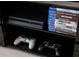 Close up of an entertainment unit with a game console and a stack of video games at 1607 Kona Ln, Davenport, FL 33897