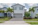 Charming two-story home with a two-car garage and well-maintained landscaping at 1607 Kona Ln, Davenport, FL 33897
