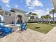Cozy fire pit with blue chairs and cornhole in the community at 1607 Kona Ln, Davenport, FL 33897