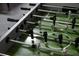 Close up of a foosball table showing the details of the figurines, poles, and playing field at 1607 Kona Ln, Davenport, FL 33897