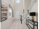 Bright foyer with high ceilings, decorative console table, and staircase creates a welcoming entrance at 1607 Kona Ln, Davenport, FL 33897
