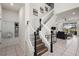 Bright foyer with tile flooring, coat rack, and staircase leading to the second floor at 1607 Kona Ln, Davenport, FL 33897