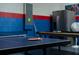 A spacious game room featuring a ping pong table, pool table, and vibrant red and blue color scheme at 1607 Kona Ln, Davenport, FL 33897