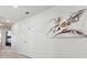 Hallway featuring modern art, white walls, and a glimpse of a bunk room at 1607 Kona Ln, Davenport, FL 33897