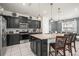 Modern kitchen with stainless steel appliances, granite countertops, and a large center island at 1607 Kona Ln, Davenport, FL 33897