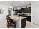 Modern kitchen features a center island with granite countertops and dark wood cabinets at 1607 Kona Ln, Davenport, FL 33897