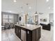Open concept kitchen with large island and granite countertops at 1607 Kona Ln, Davenport, FL 33897