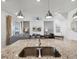 Open-concept kitchen view overlooking the sink area and living space at 1607 Kona Ln, Davenport, FL 33897