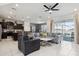Open-concept living room featuring tile floors, ceiling fan, and sliding glass doors at 1607 Kona Ln, Davenport, FL 33897