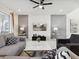 Comfortable living room boasts stylish furniture, neutral tones, and sliding glass doors to a patio at 1607 Kona Ln, Davenport, FL 33897