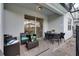 Covered back patio boasts modern decor with comfortable wicker furniture, perfect for relaxing and entertaining outdoors at 1607 Kona Ln, Davenport, FL 33897