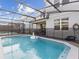 Relaxing screened pool with a unicorn floatie in the backyard at 1607 Kona Ln, Davenport, FL 33897
