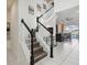 Modern staircase with white railing and dark wood steps at 1607 Kona Ln, Davenport, FL 33897