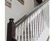 Modern staircase with white railing and dark wood steps at 1607 Kona Ln, Davenport, FL 33897