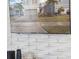 A television with decorative brick surround plays a video of the house at 1607 Kona Ln, Davenport, FL 33897