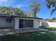 Spacious backyard with a wooden deck, green grass, and a white privacy fence at 2009 S Osceola Ave, Orlando, FL 32806