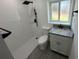 Updated bathroom with walk-in shower, toilet and granite vanity at 2009 S Osceola Ave, Orlando, FL 32806