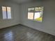 Bright bedroom with wood-look tile flooring and two windows overlooking the backyard at 2009 S Osceola Ave, Orlando, FL 32806