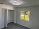 This bedroom features a ceiling fan and large window with a view of the neighborhood at 2009 S Osceola Ave, Orlando, FL 32806