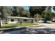 Charming single-story home features a well-maintained lawn and a paved driveway leading to an attached garage at 2009 S Osceola Ave, Orlando, FL 32806