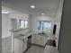 Open kitchen with granite countertops and stainless steel appliances adjoins the living area at 2009 S Osceola Ave, Orlando, FL 32806