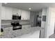 Kitchen with granite countertops, white cabinets, and a breakfast bar at 2009 S Osceola Ave, Orlando, FL 32806