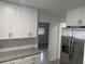 Modern kitchen with stainless steel appliances and white cabinets at 2009 S Osceola Ave, Orlando, FL 32806