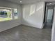 Spacious living room with large windows and gray tile floors at 2009 S Osceola Ave, Orlando, FL 32806