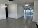 Open concept living area with gray tile floors and access to patio at 2009 S Osceola Ave, Orlando, FL 32806