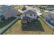 Aerial view of home showcasing a spacious backyard, patio with shades, and a fenced perimeter at 2211 Bittle Way, St Cloud, FL 34769