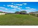 Expansive backyard featuring a lawn, privacy fence, and lush surroundings at 2211 Bittle Way, St Cloud, FL 34769