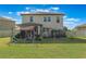Spacious backyard featuring a lawn, play set, covered patio, and privacy fence at 2211 Bittle Way, St Cloud, FL 34769