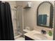 Cozy bathroom featuring a shower-tub combination, vanity, toilet, and decorative mirror at 2211 Bittle Way, St Cloud, FL 34769