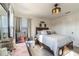 Bedroom featuring a queen bed, bright window, and neutral-toned decor at 2211 Bittle Way, St Cloud, FL 34769
