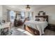 Cozy bedroom featuring a queen bed, natural light, and hardwood flooring at 2211 Bittle Way, St Cloud, FL 34769