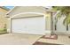 White garage door and front entry to house at 2318 Andrews Valley Dr, Kissimmee, FL 34758