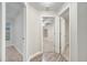 Hallway with carpeted bedrooms and wood-look flooring at 2318 Andrews Valley Dr, Kissimmee, FL 34758