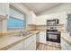 Bright kitchen featuring white cabinets and stainless steel appliances at 2318 Andrews Valley Dr, Kissimmee, FL 34758