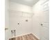 Bright laundry room with wire shelving and vinyl flooring at 2318 Andrews Valley Dr, Kissimmee, FL 34758
