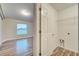 Laundry room with white door and wood-look floors at 2318 Andrews Valley Dr, Kissimmee, FL 34758