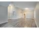 Open living room with wood-look floors and kitchen view at 2318 Andrews Valley Dr, Kissimmee, FL 34758