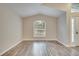 Living room with vaulted ceiling, wood floors, and window at 2318 Andrews Valley Dr, Kissimmee, FL 34758