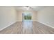 Bright living room with wood-look flooring and sliding glass doors at 2318 Andrews Valley Dr, Kissimmee, FL 34758