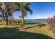 Lake view from the backyard with lush landscaping at 241 Lake Thomas Dr, Winter Haven, FL 33880