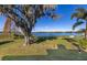 Spacious backyard with a lake view and string lights at 241 Lake Thomas Dr, Winter Haven, FL 33880