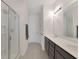 Bathroom with a glass shower and double sink vanity at 2587 Summer Star Way, Leesburg, FL 34748