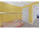 Cozy bedroom with yellow walls, a simple wooden bed frame and plush carpeting at 2587 Summer Star Way, Leesburg, FL 34748