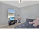 Serene bedroom featuring a bed with galaxy-themed bedding and a calming color palette at 2587 Summer Star Way, Leesburg, FL 34748